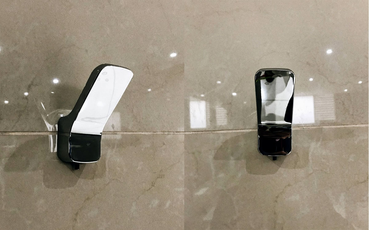 A single hook made of metal, chrome, screwed to a wall. Found at Club Mundet in Mexico City, Mexico, 2021.