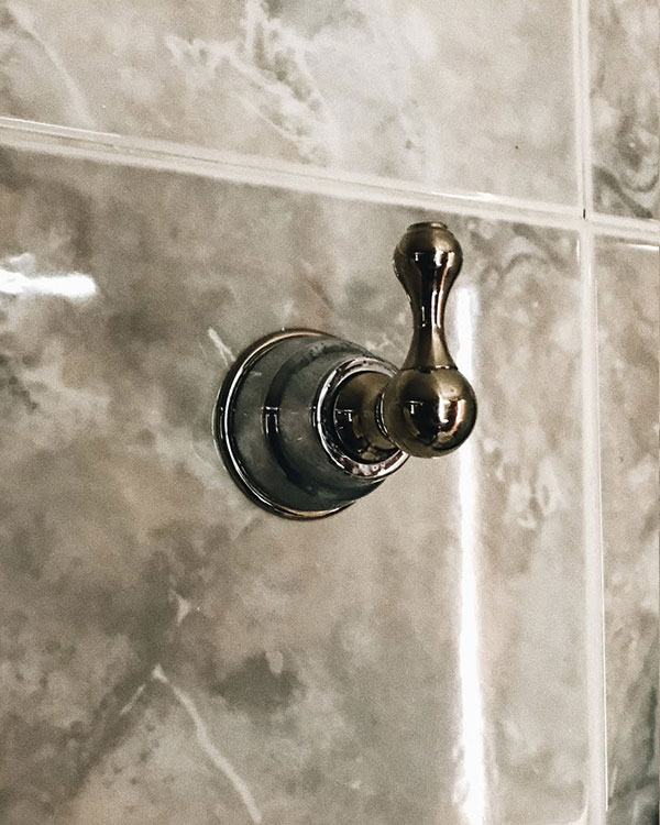 A single hook made of metal, chrome, screwed to a wall. Found on a private home in Acapulco, Mexico, 2022.