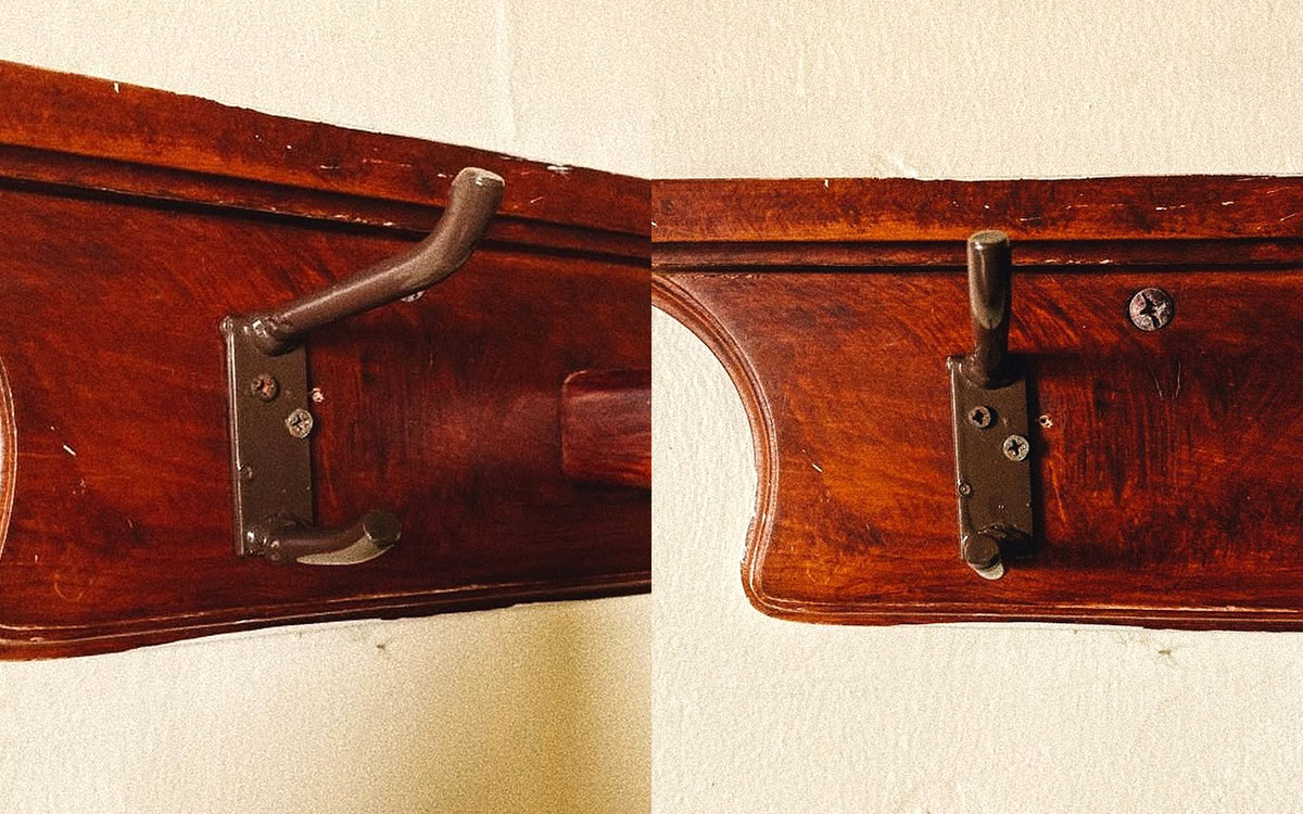 A double hook made of metal, brown paint, screwed to a piece of wood. Found at Baños Termales de Ojocaliente in Aguascalientes, Mexico, 2022.