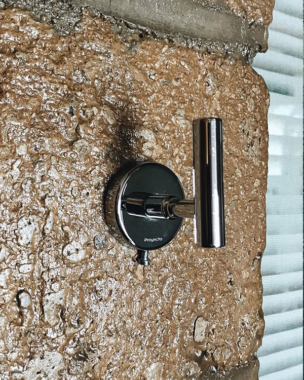 A single hook made of metal, chrome, screwed to a wall. Found on a private home in Aguascalientes, Mexico, 2022.