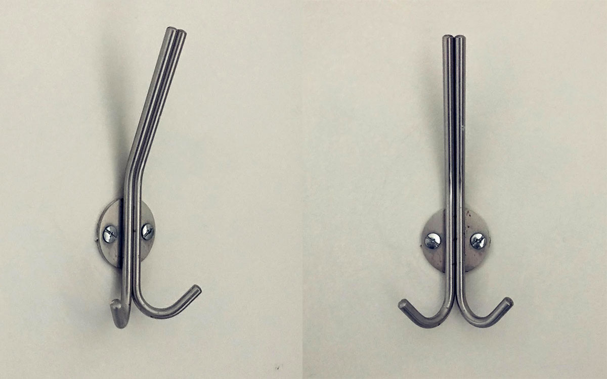 A triple hook made of metal, nickel, screwed to a wall. Found on a hospital in Mexico City, Mexico, 2022.