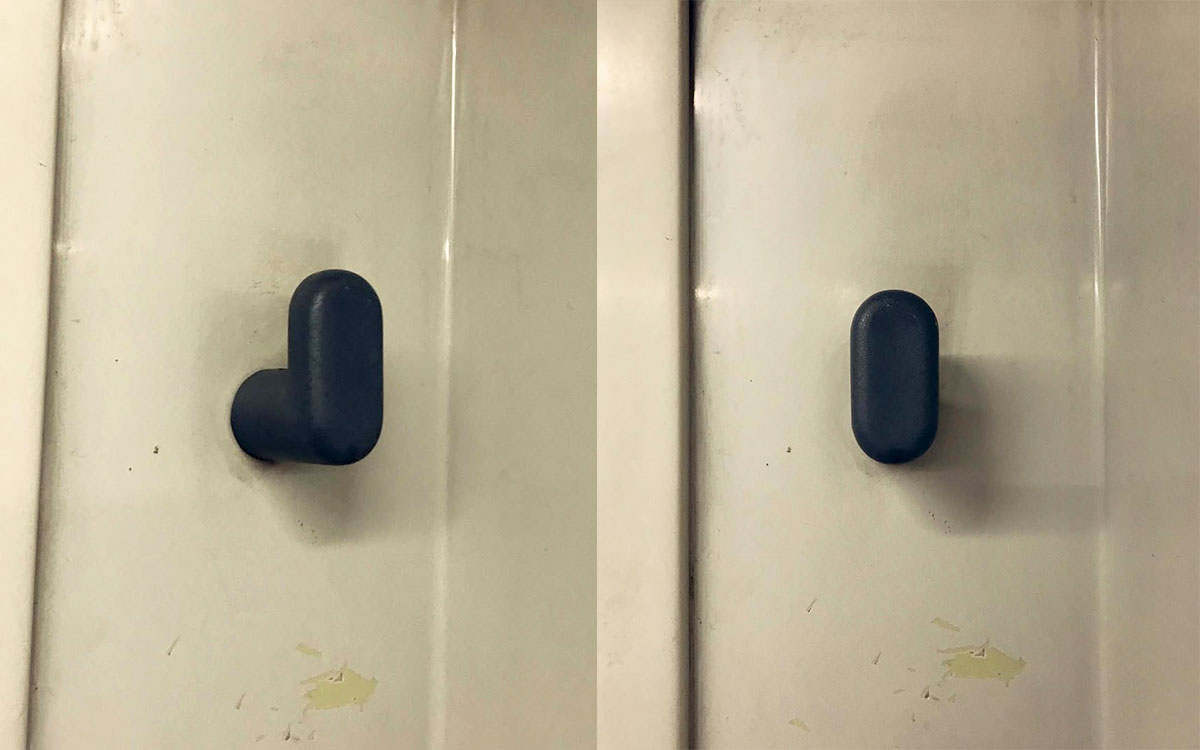 A single hook made of gray plastic, screwed to a wall. Found on a train in Barcelona, Spain, 2022.