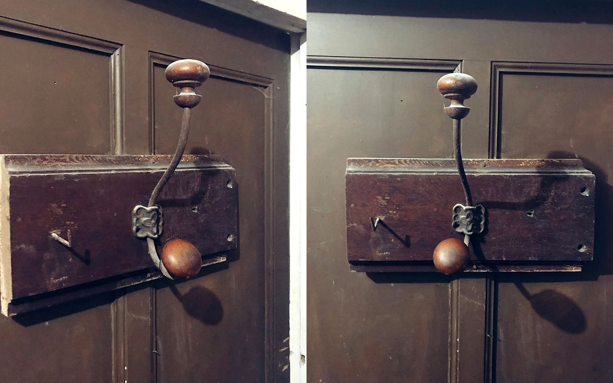 A double hook made of metal and wood, brass, screwed to a piece of wood. Found on a private home in Apt, France, 2022.