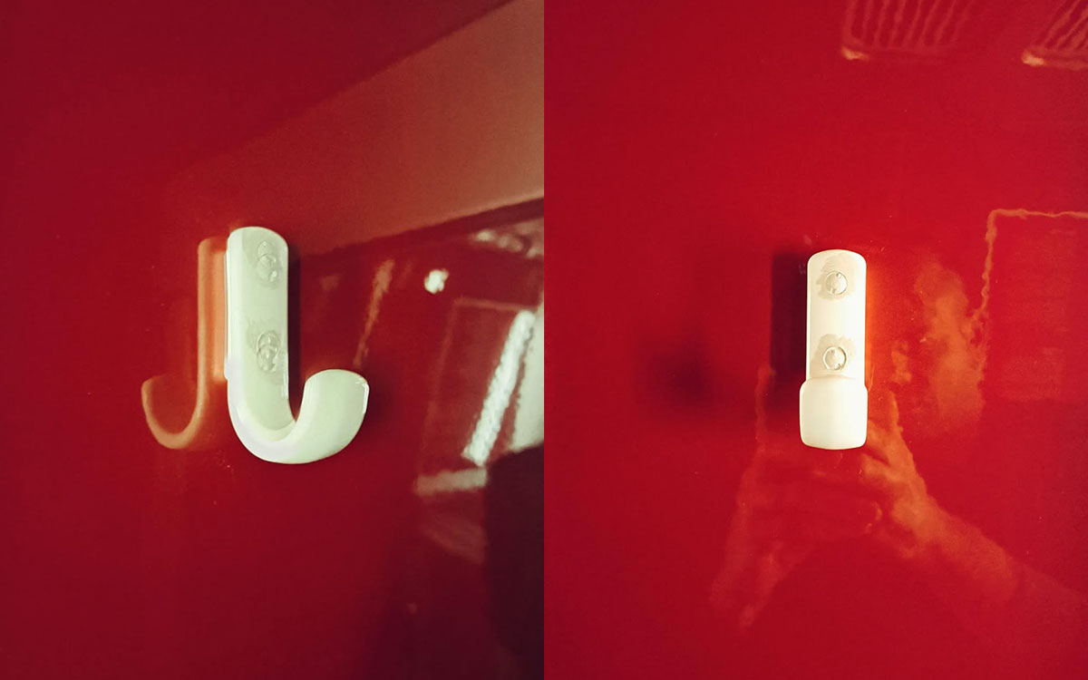 A single hook made of ivory plastic, screwed to a wall. Found on a train in Amsterdam, Netherlands, 2023.