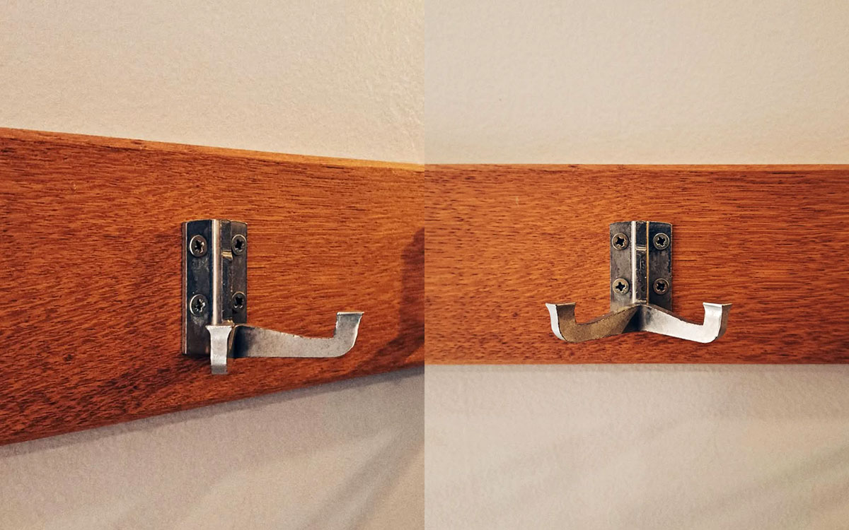 A double hook made of metal, nickel, screwed to a piece of wood. Found at Centre Belge de la Bande Dessinée in Brussels, Belgium, 2023.