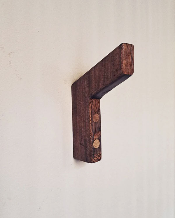 A single hook made of wood, screwed to a wall. Found on a private home in Puerto Escondido, Mexico, 2024.