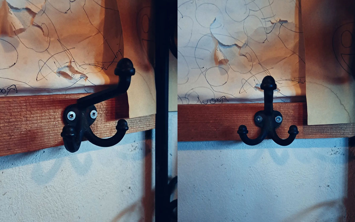 A triple hook made of metal, black paint, screwed to a wall. Found on a private home near Montreal, Canada, 2024.
