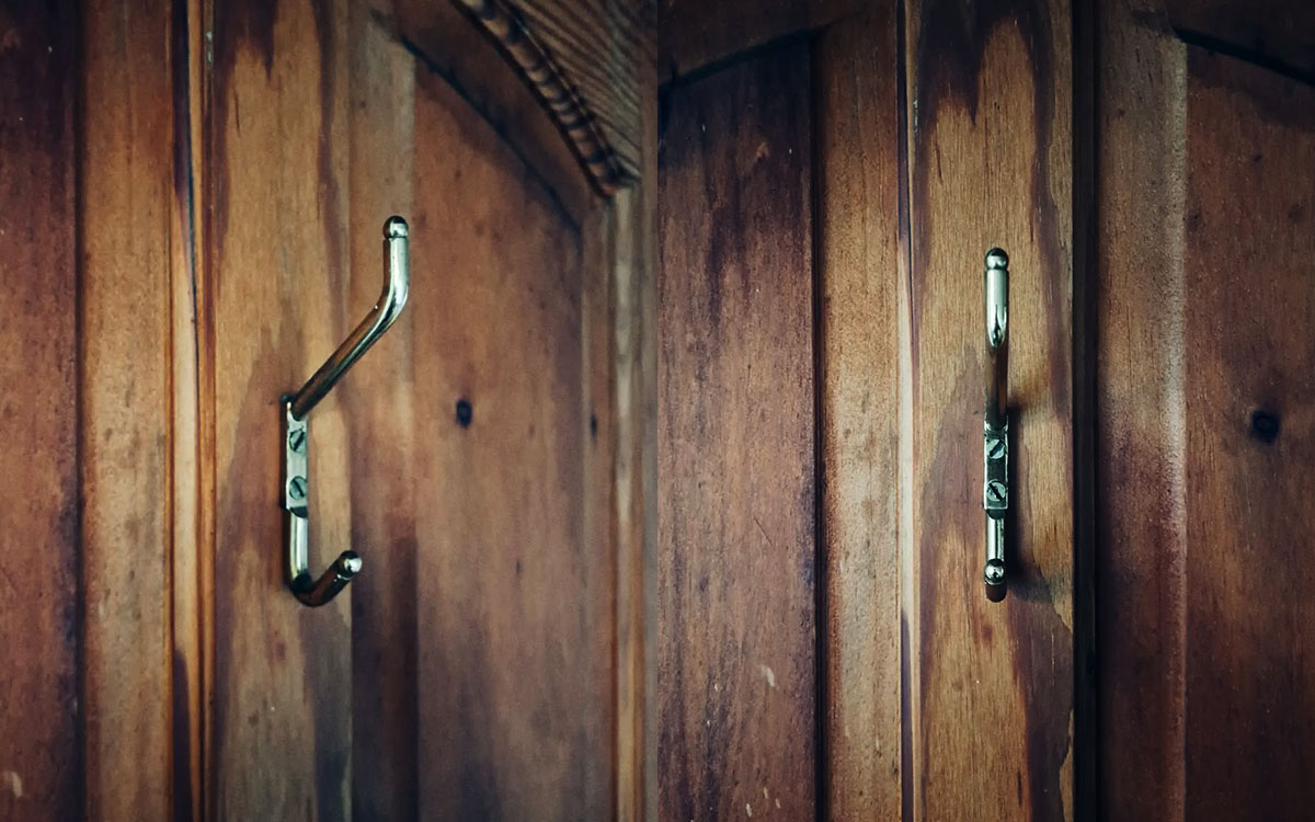 A double hook made of metal, brass, screwed to a door. Found on a private home in Malinalco, Mexico, 2024.