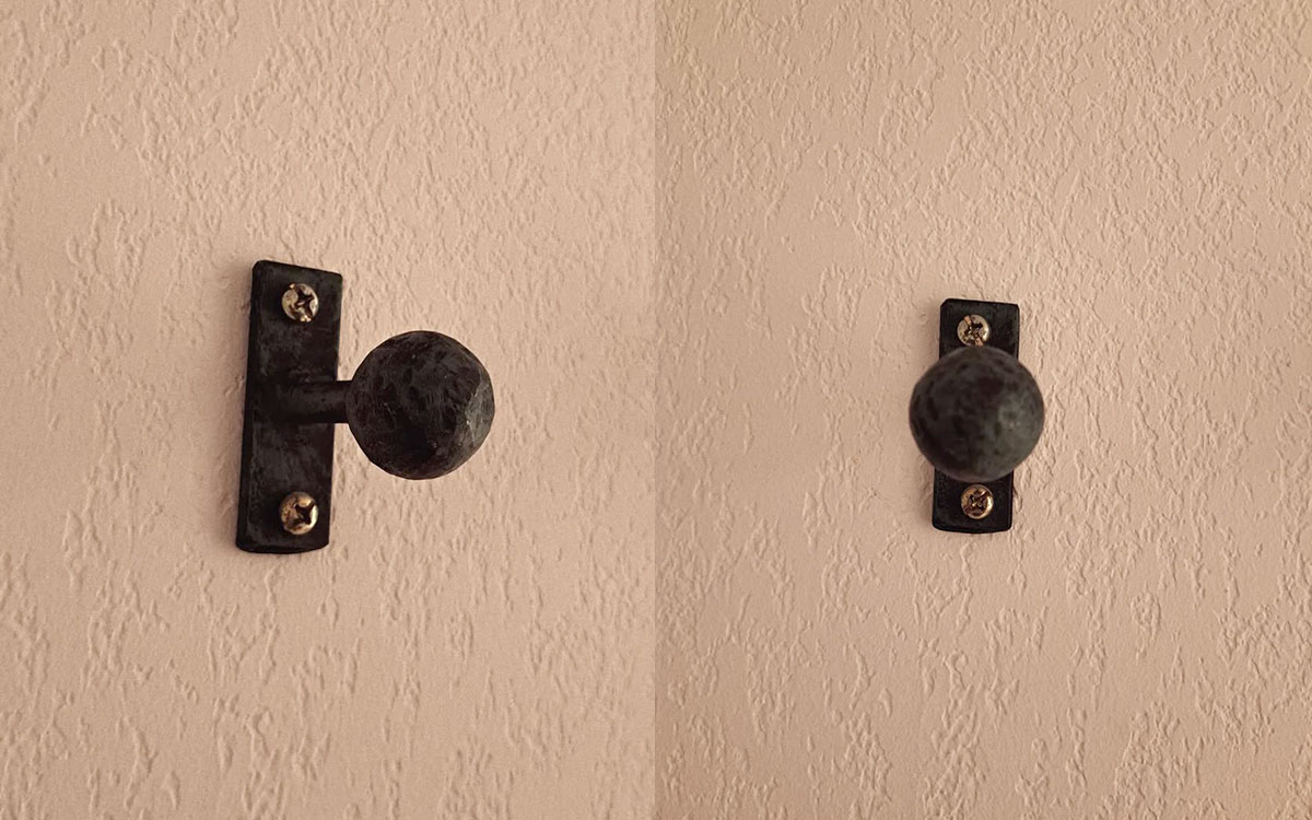 A single hook made of metal, screwed to a wall. Found on a hotel in Avignon, France, 2024.