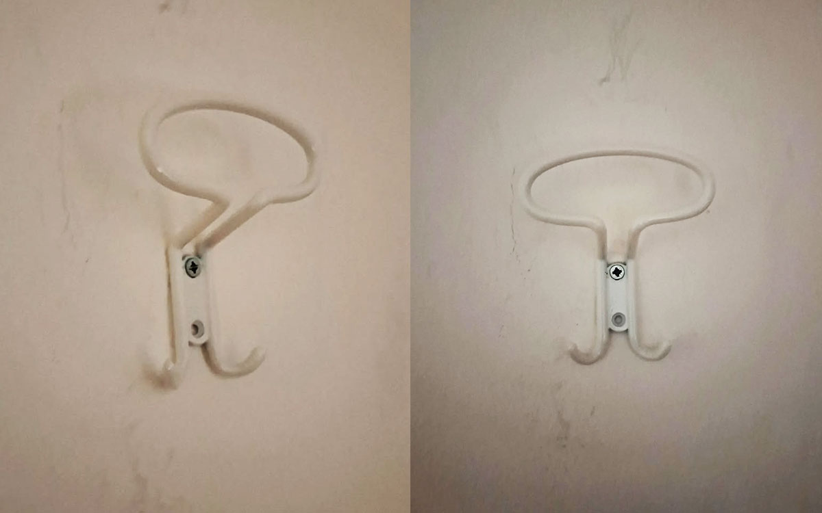 A triple hook made of metal, white powder coating, screwed to a wall. Found on a hotel in Pietra Ligure, Italy, 2024.