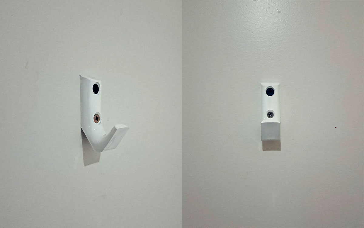 A single hook made of white plastic, screwed to a door. Found on a hotel in Lyon, France, 2024.