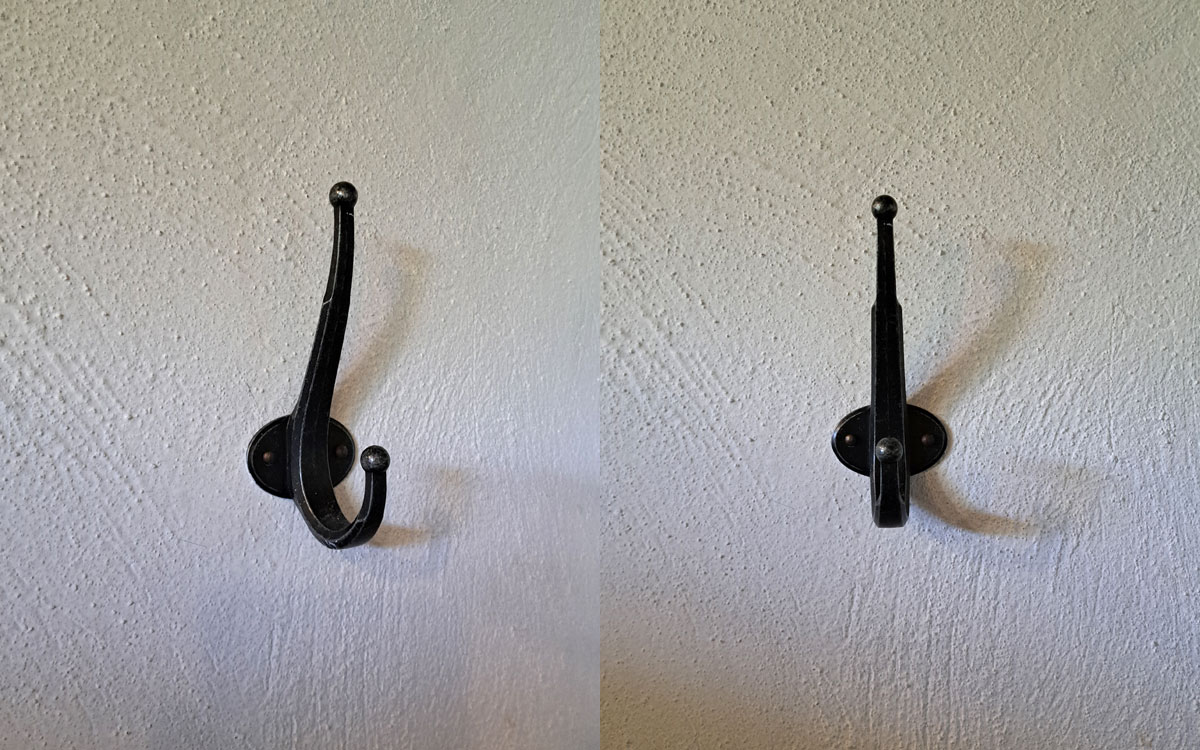 A double hook made of metal, nickel, nailed to a wall. Found on a private home in Tepoztlan, Mexico, 2025.